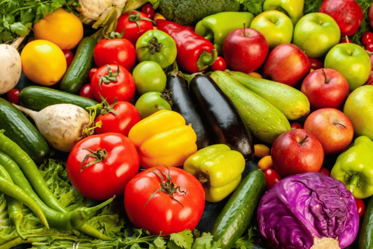 Fresh assorted Vietnamese fruits and vegetables – peppers, tomatoes, cucumbers, carrots, cabbage – exported produce for high-demand global markets.
